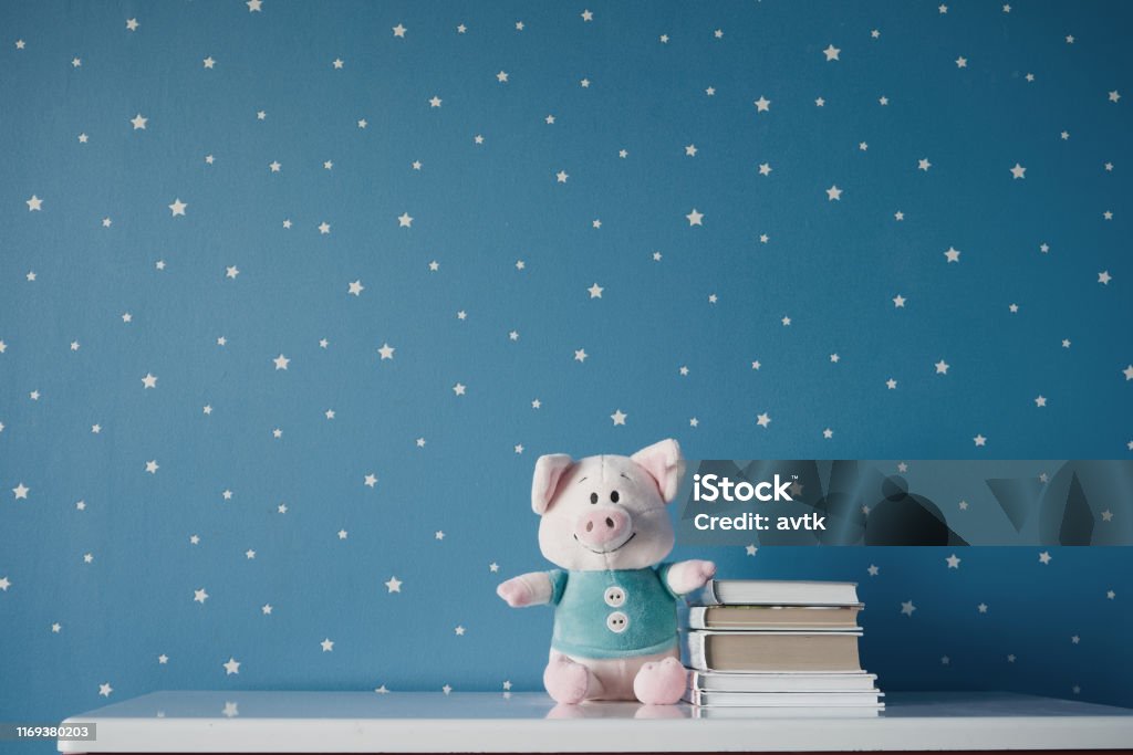 lindo cerdo de juguete y libros en la mesa - Foto de stock de Dormitorio infantil libre de derechos