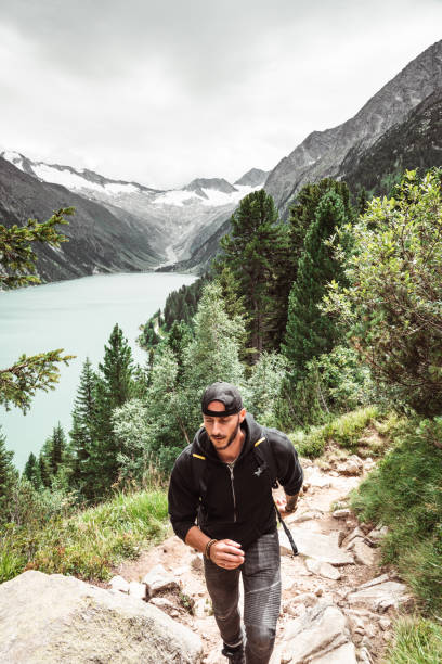 istock man hiking in the mountain 1169380923