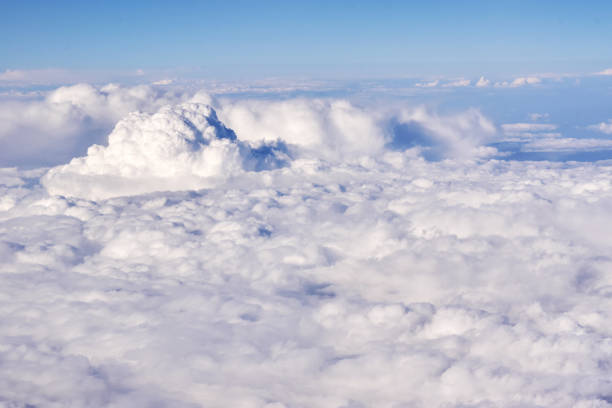 aerial view of fluffy clouds in a stratosphere from airplane window - cloud cloudscape stratosphere above imagens e fotografias de stock