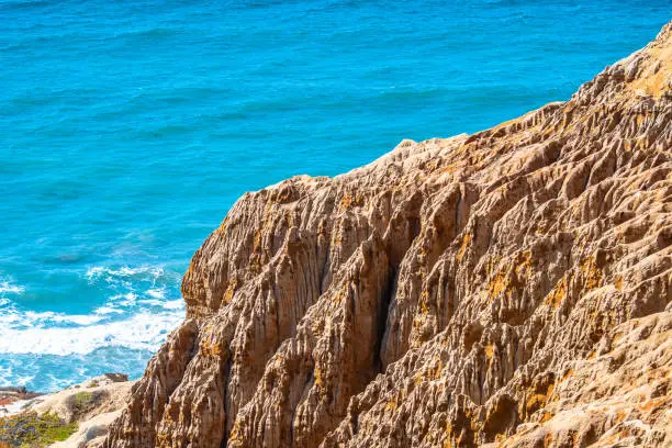 Coastline sandstone cliffs by the ocean at Torrey Pines State Park and Reserve in La Jolla, San Diego in southern California. Captivating views of unique landscape rock formation along the beach coast