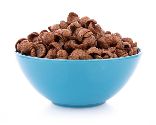 istock chocolate cereals in bowl on white background. Cornflakes 1169382573