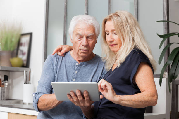 istock senior couple looking at a tablet computer 1169384538