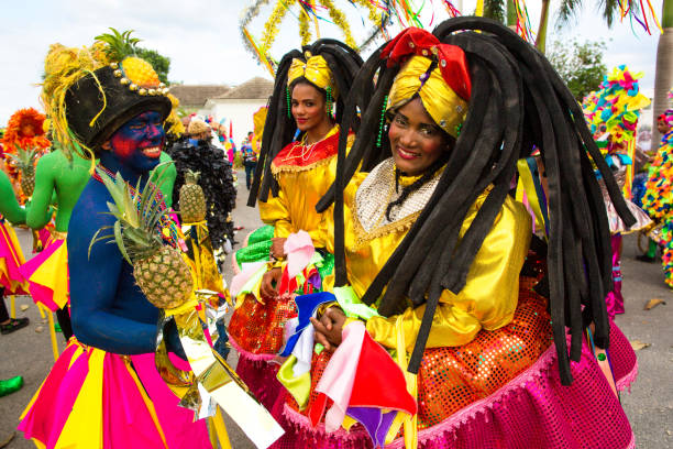 Girls in colored costumes at the festival Dominican Republic, Punta Cana - March 3, 2018: Three girls in national clothes with a pineapple in their hands at the annual carnival antilles stock pictures, royalty-free photos & images