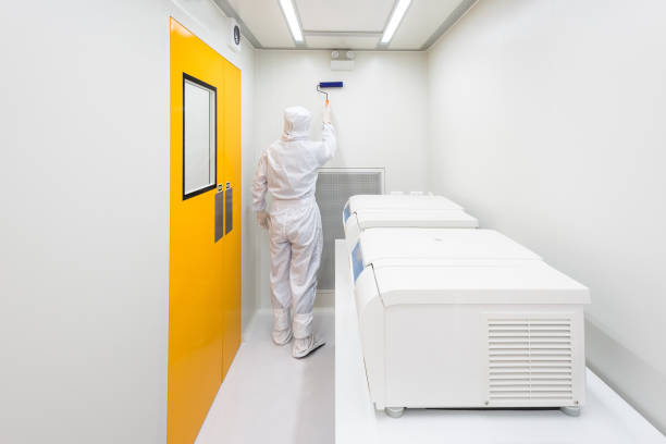 istock A scientist in sterile coverall gown using lint roller for cleaning laboratory. Cleanroom facility. 1169384939