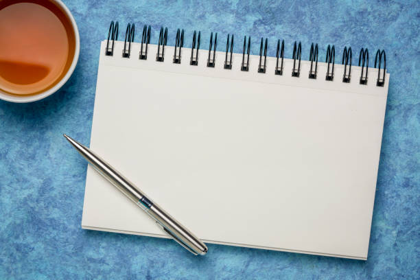 istock blank spiral art sketchbook with tea 1169386044