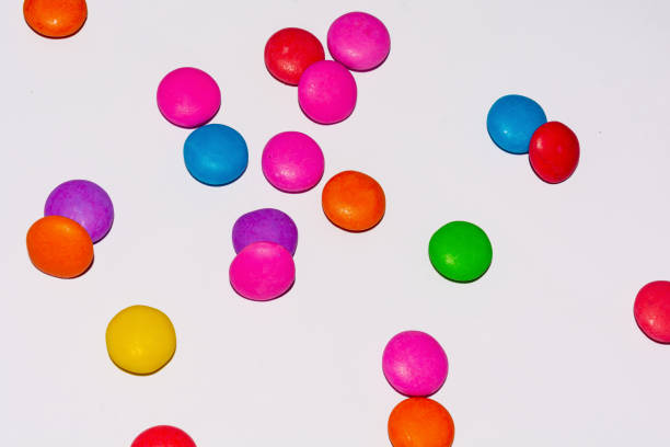 istock Chocolate coated candies on white background 1169388239