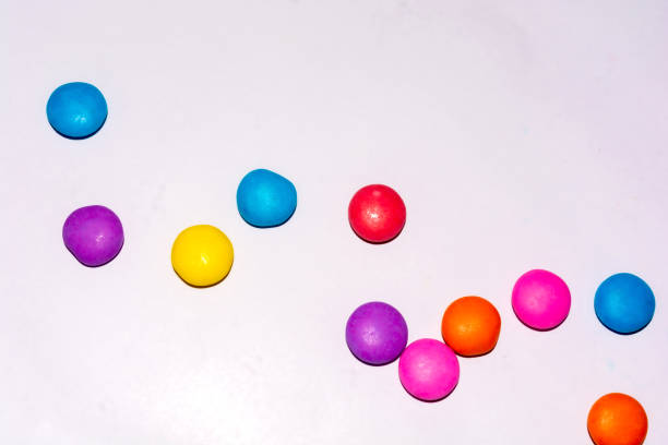 istock Chocolate coated candies on white background 1169388274