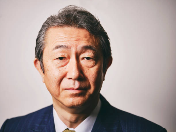 A portrait of a mature Japanese businessman wearing a business suit.
