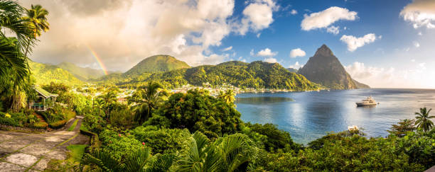St. Lucia - Caribbean Sea with Pitons and Rainbow Caribbean World Heritage Site taken shortly before tropical rain shower caribbean islands stock pictures, royalty-free photos & images