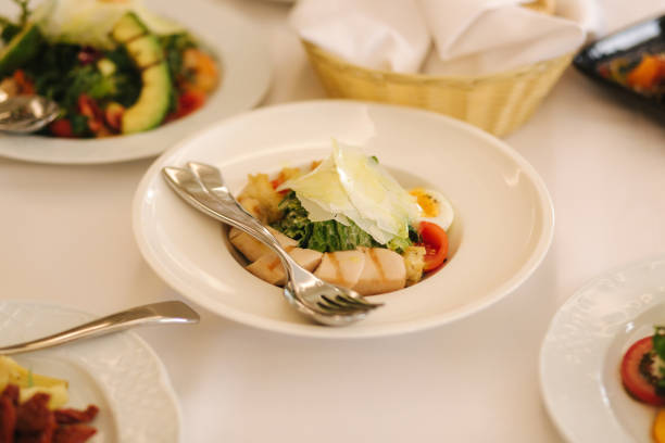 istock Fresh salad in restaurant on the table. Banquet concapt. Different salads with tomato, arugula, chicken, avocado, parmesan, shrimp 1169404330