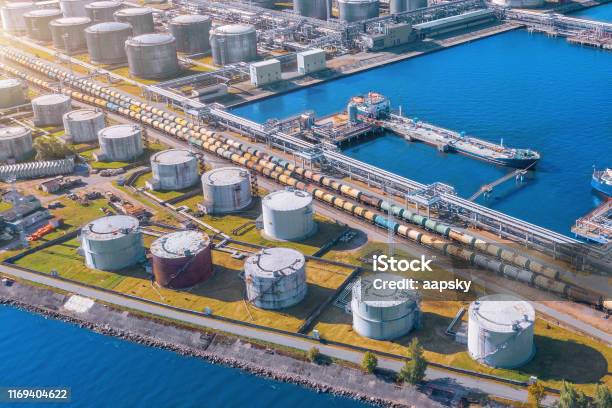 Aerial View Large Port Oil Loading Terminal With Large Storage Tanks Railway Infrastructure For The Delivery Of Bulk Cargo By Sea Using Pump Station In Ship Tanker For Transportation And Delivery Stock Photo - Download Image Now
