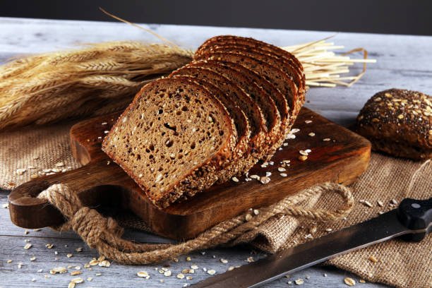 istock freshly baked bread on wooden board. cutted organic bread 1169408973