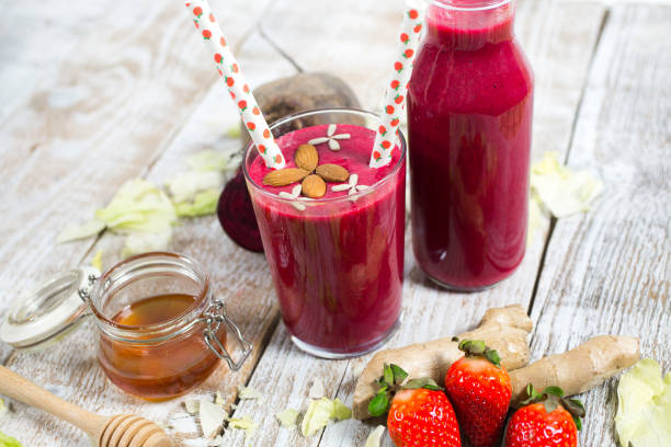smoothies with beetroot, strawberries, ginger and honey stock photo