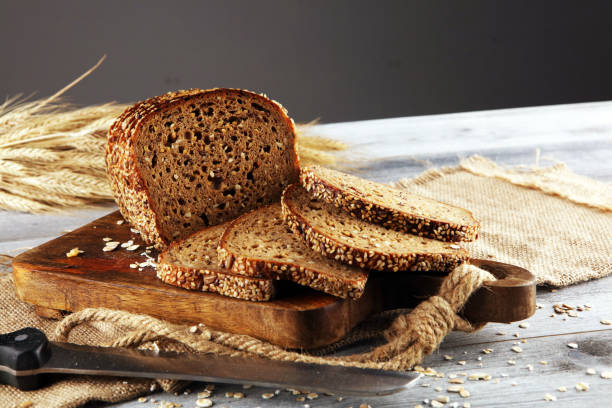 istock freshly baked bread on wooden board. cutted organic bread 1169409097