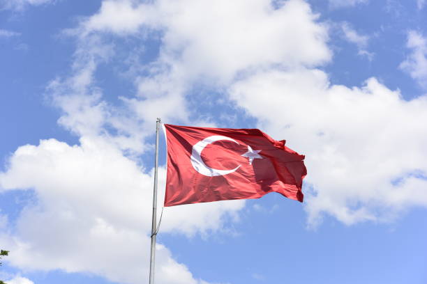 istock Turkish flag waving in the sky 1169412878