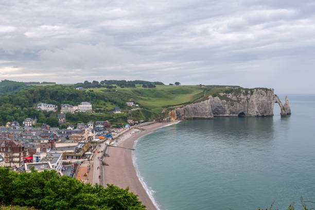 istock Etretat: the village, beach, mountains and cliffs on a cloudy day 1169413152