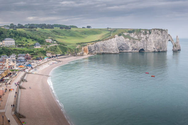 istock Etretat: the village, beach, mountains and cliffs on a cloudy day 1169413154
