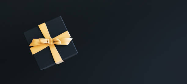 istock Mock-up poster, black gift box with golden bow on black background, 3D Render, 3D Illustration 1169414603