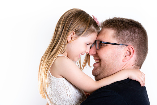 Father's day. Happy family daughter hugging dad and laughs on holiday. White Background, copy space.