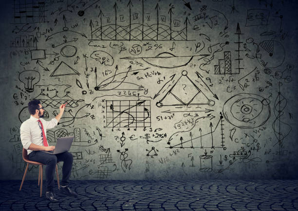 istock Businessman with computer drawing business plan on the wall 1169416025