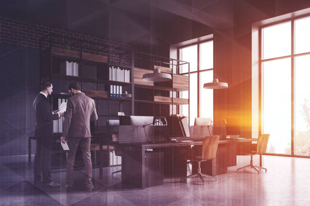 istock Businessmen in gray office corner 1169417224