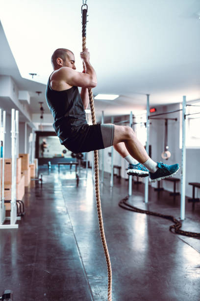 istock Male Climbing Rope In Gym 1169417607