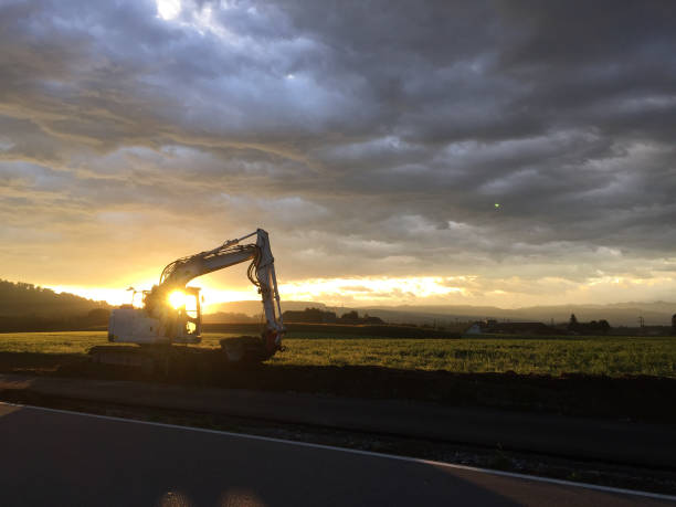 istock excavator during sunrise 1169418685