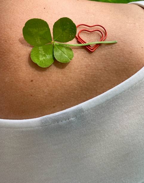 istock Four leaf clover and a double heart  on woman's shoulder 1169419826