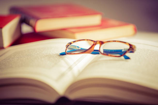 istock Glasses lies on red books 1169420000