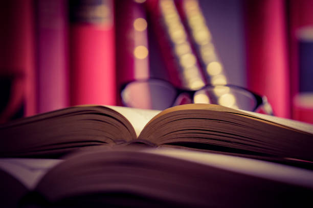 istock Glasses lies on red books 1169420032
