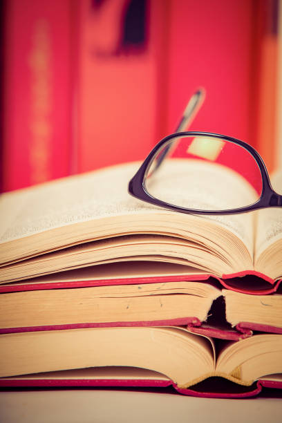 istock Glasses lies on red books 1169420035