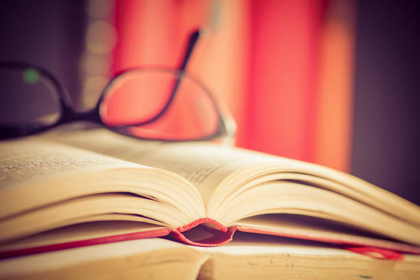 istock Glasses lies on red books 1169420049
