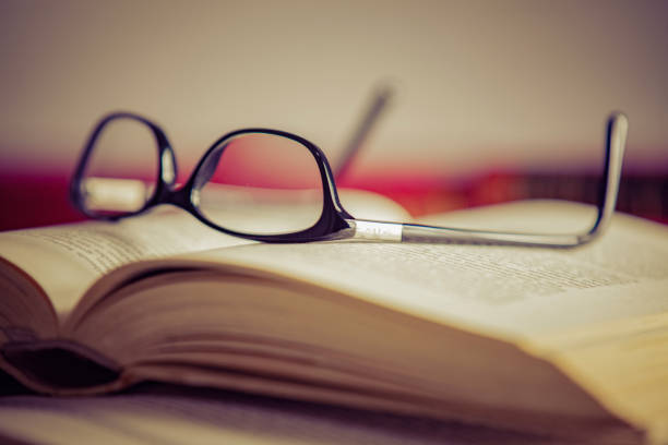 istock Glasses lies on red books 1169420092