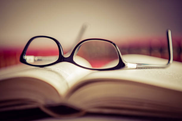 istock Glasses lies on red books 1169420238