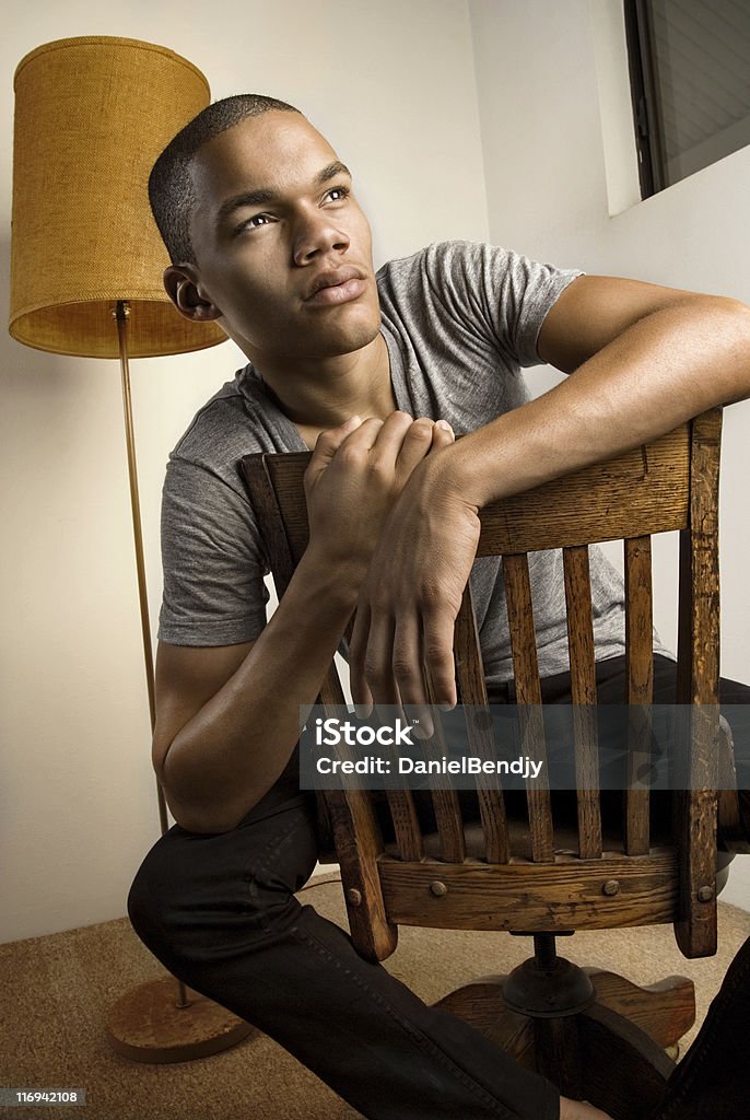 Young Man In Apartment Young man in bare apartment. 18-19 Years Stock Photo