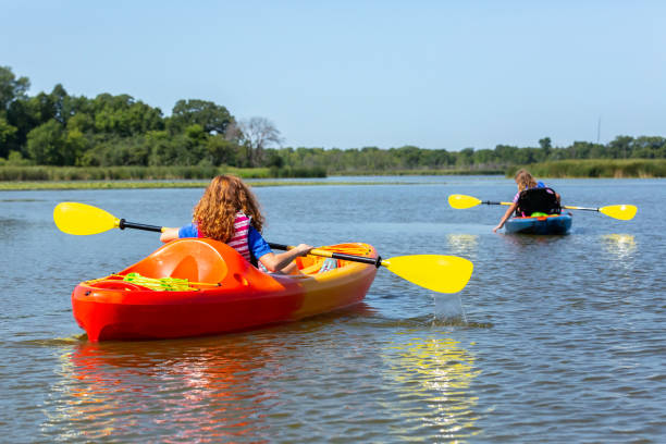 istock Two Girls Kayaking on Lake in Summer 1169423514