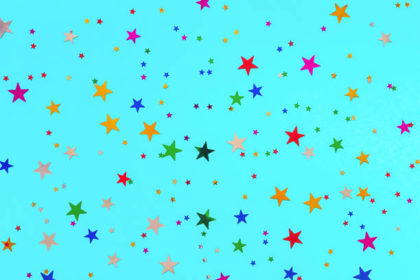 istock Multicolored stars sprinkles on turquoise backdrop. Festive holiday background. for your projects. Celebration concept. Christmas pattern. Top view, flat lay 1169423687