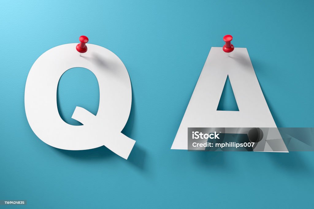 Questions and Answers Q and A Concept Questions and answers paper Q and A with red thumbtack pinned to blue paper background with no people. Letter Q Stock Photo