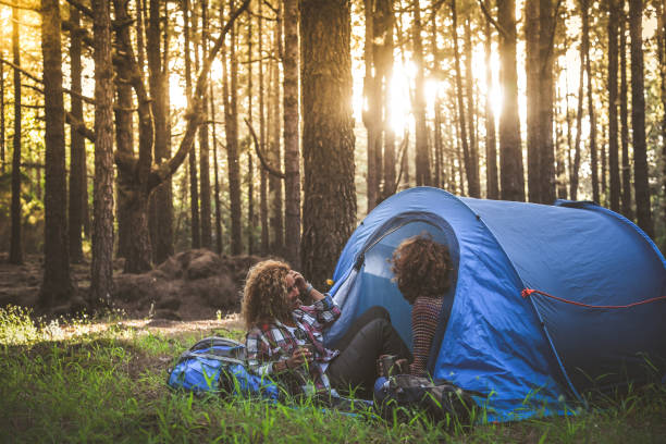 istock Two Women Sitting In Tent At Forest 1169427715