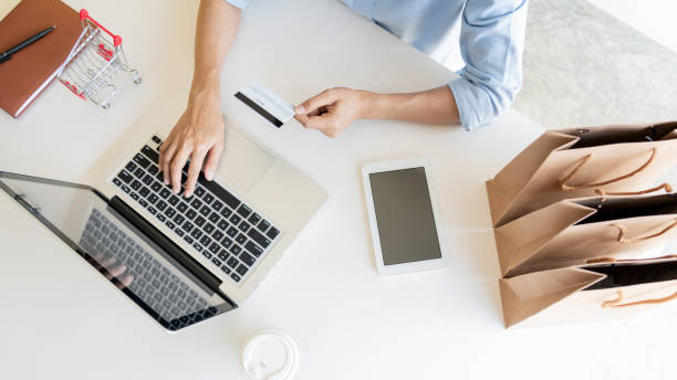 istock Midsection Of Man Holding Coffee Cup While Using Laptop On Table 1169429518