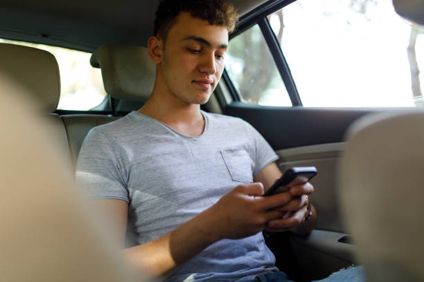 istock Passenger in car using smart phone 1169430474