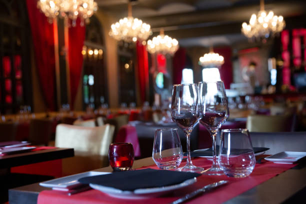 istock Empty wine glasses stand on table in restaurant 1169430527