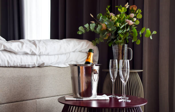 Romantic setting in the bedroom with champagne and fresh flowers