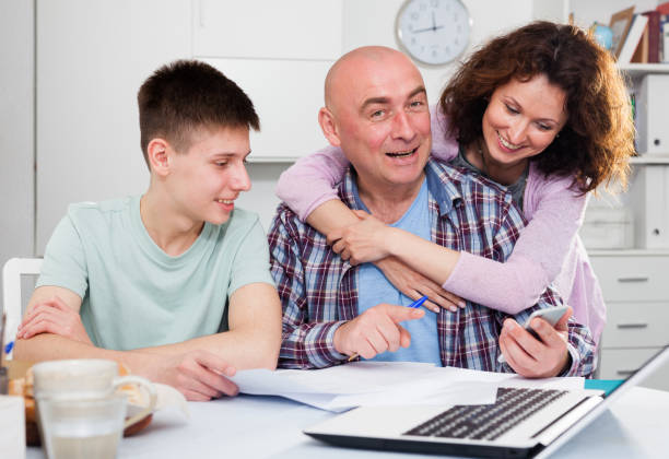 istock Happy family with papers 1169431363