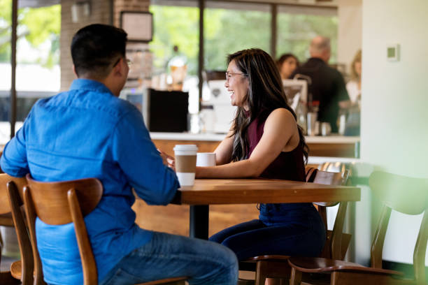 istock Couple laugh while having a cup of coffee 1169431465