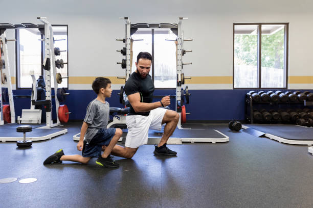 istock Uncle instructs nephew in correct lunge technique 1169431762