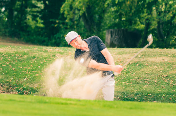istock A golf pro with a perfect bunker shot. 1169432846