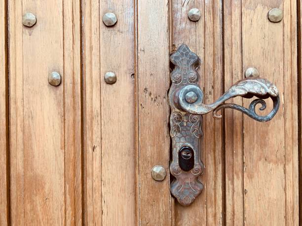 istock Door handle on old  medieval door 1169433251
