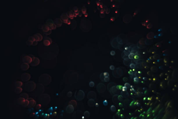 istock Beautiful multi colored light bokeh on a black background. 1169433379