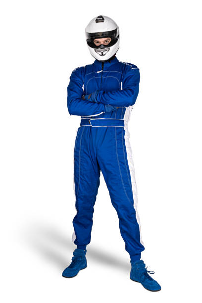 Determined race driver in blue white motorsport overall shoes gloves and integral safety crash helmet isolated white background. Car racing motorcycle sport concept. stock photo